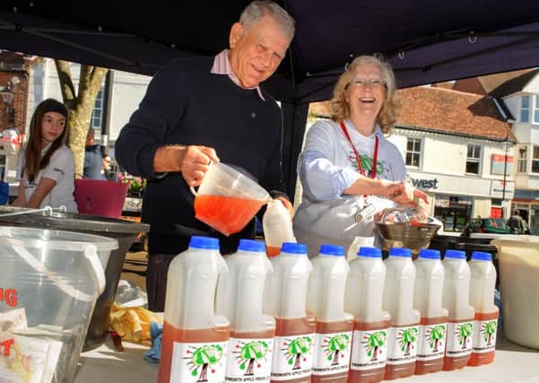 Bottling apple juice at last year's Apple Pressing event were John Coombs and Jenny Edgell / Picture: Allan Hutchings