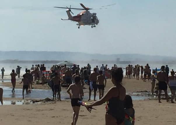 A coastguard helicopter has been seen above Camber Sands days after five men lost their lives at the beach. Picture taken on August 26 by Michelle Brown