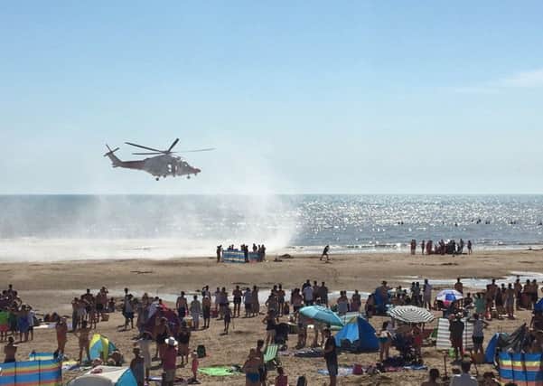 The air ambulance landing on the beach at Camber Sands. Photo by @Tashka4 on Twitter