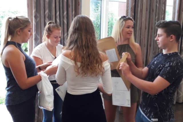 Students opening their result envelopes