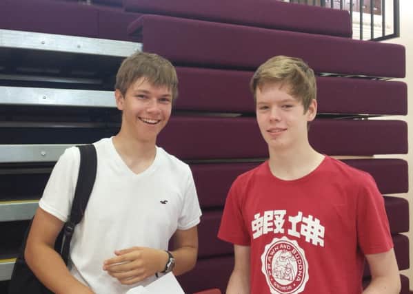 Ed Gilbert (left), 16, and Rudi MacPherson, 16, celebrate their results