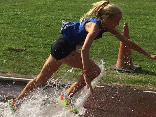 Ellen Crombie tackles the water jump in the steeplechase. Picture courtesy Terry Skelton