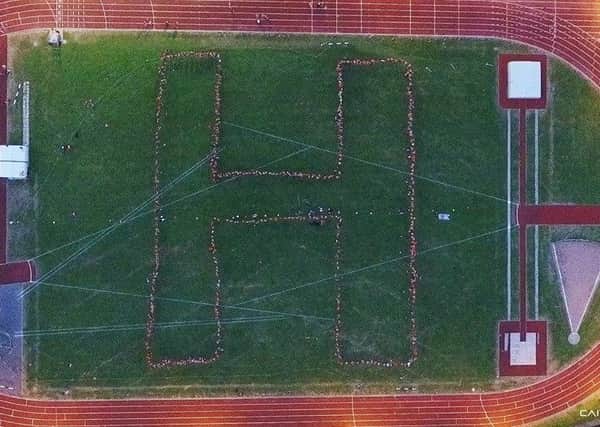 A giant H formed out of visitors who went to the fitness fundraiser in memory of Hughie