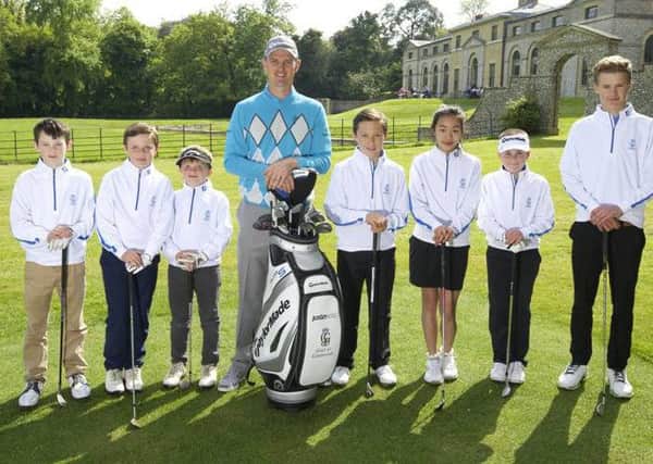 Justin Rose, pictured at Goodwood with some of the club's juniors in 2014