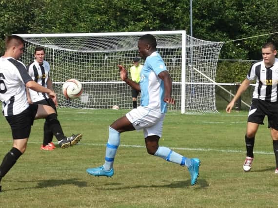 Bexhill United midfielder Georges Gouet closes down a St Francis Rangers opponent. Picture courtesy Mark Killy