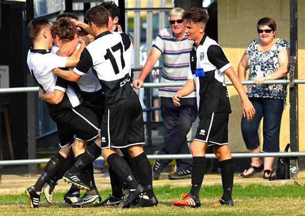 Jared Rance is mobbed by his team-mates after scoring against Billingshurst. Picture: Stephen Goodger