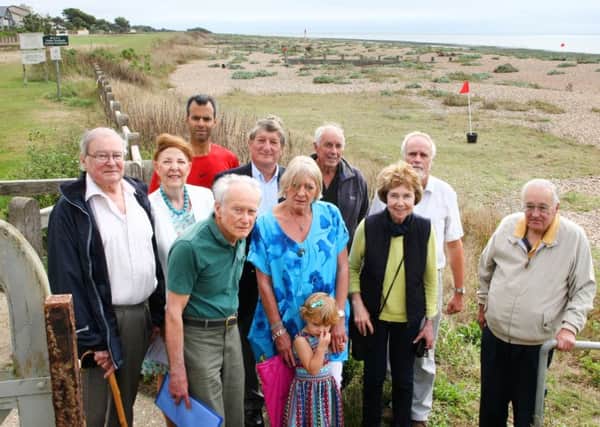 Residents and parish councillors gather by the site proposed for a dinghy compound on Kingston Beach