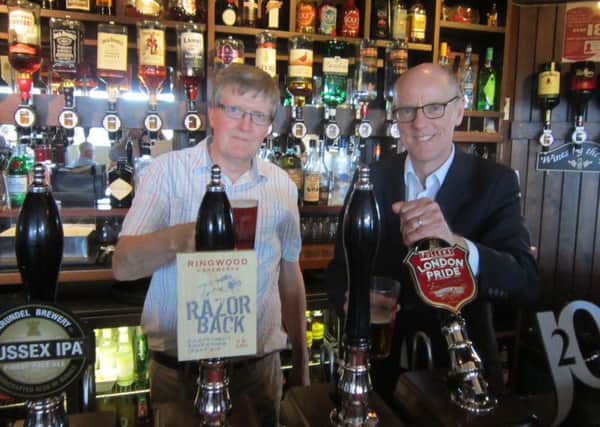 Paul Crease, left, with Nick Gibb at the bar of the Arun View