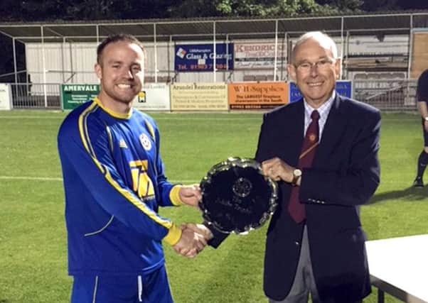 Dennis Leonard presents the trophy to Westbourne FC