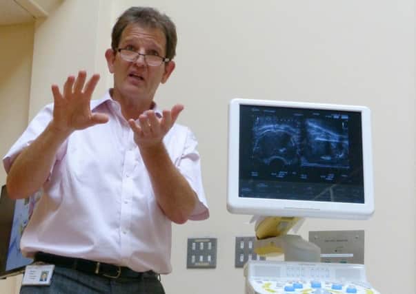 Consultant surgeon Paul Carter with the prostate template biopsy machine at St Richard's hospital