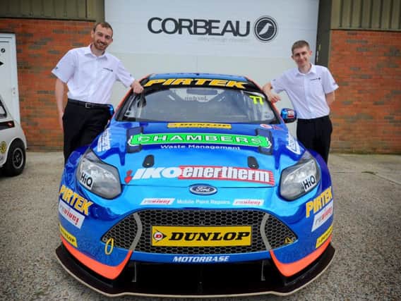 Sales executives Daniel Read and Steve Hannon with Andrew Jordan's British Touring Car.