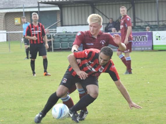 Liam Foster tussles for possession during Little Common's 4-1 win at home to Oakwood. Picture by Simon Newstead