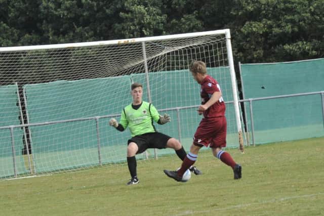 Jamie Crone scores Little Common's second goal in their 4-1 win at home to Oakwood on Saturday.