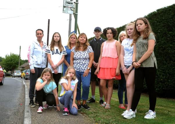 Anger over school bus time changes in Faygate. Parents and children say that the changes will mean that the children will have to walk along the the busy A264. Pic Steve Robards  SR1625902 SUS-160609-170600001