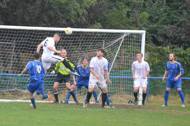 Josh Spinks jumps highest to head home the first goal. Raynes Park Vale v Haywards Heath Town. Picture by Grahame Lehkyj