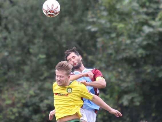 Ollie Rowe goes up for a header during Hastings United's 3-0 league win at home to Godalming Town on Saturday. Picture courtesy Scott White