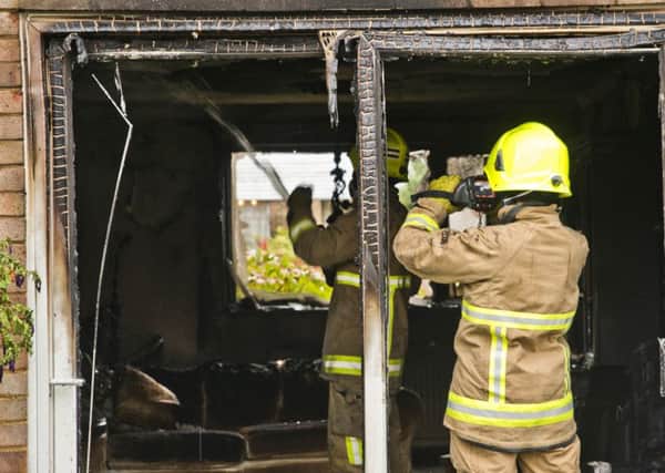 Firemen at the scene of the blaze in Walesbeech, Furnace Green. Photo: Eddie Howland SUS-160913-110643001