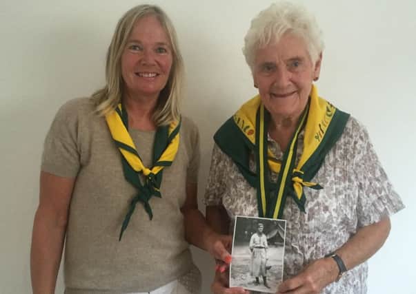 Angela Browne (left) and Mary-Rose Barclay Willis holding a photograph of their late relative, Vera Barclay