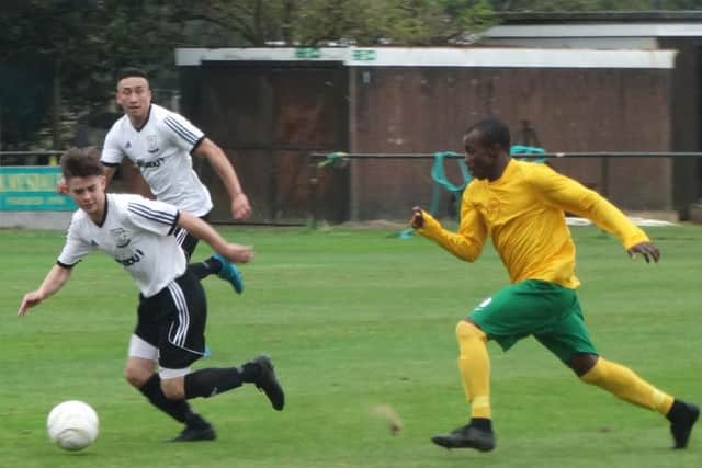 Kyle Holden seeks to escape the attentions of a Holmesdale opponent. Picture courtesy Mark Killy