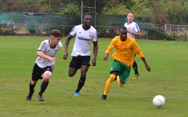 Bexhill United's Kyle Holden (left) and Georges Gouet (centre) challenge Holmesdale's Adriano Lawson during last weekend's FA Vase clash. Picture courtesy Alan Coomes