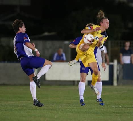 Harry Stannard feels the full force of a Herne Bay clearance during Hastings United's midweek cup win. Picture courtesy Scott White