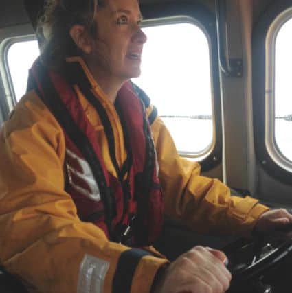 Amber Rudd at the helm of the lifeboat Sealink Endeavour SUS-160915-153452001