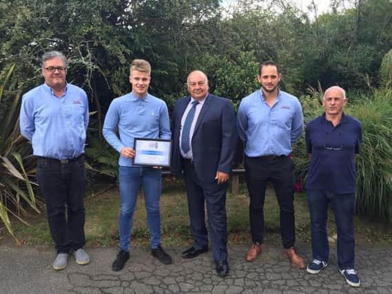 Declan (second left) being presented with the certificate by Denis Bonnici. Also shown are Phil Hamblett (left), Chris Smith (second right) and Nick Smith all of N Smith Electrical