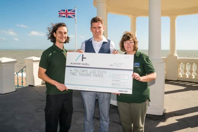 Alastair Hazell presents a cheque to Mallydams in Bexhill. Picture by Simon Newbury SUS-160916-155452001