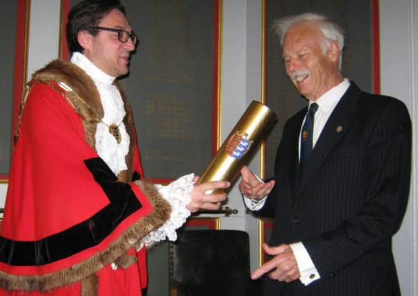 Mayor Jonathan Breeds presents the scroll to Frank Palmer