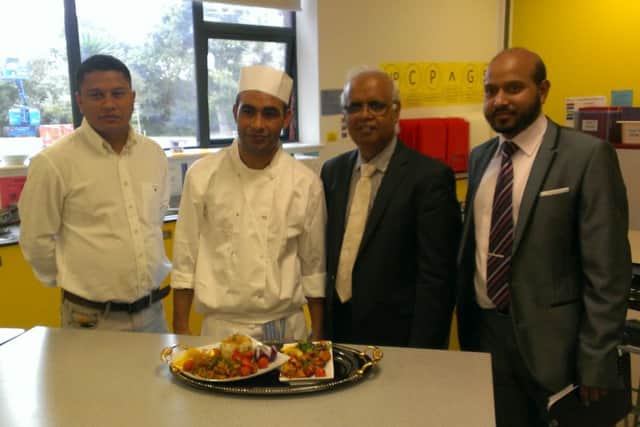 A competitor with judge Eafor Ali, president of the Bangladesh Caterers Association UK (pictured centre right) and co-organiser Abdul Noor (right).