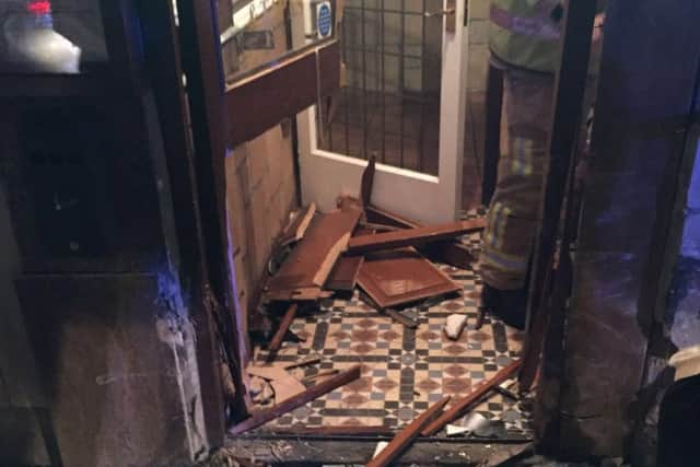 A door to the restaurant appears to have been mostly destroyed in the incident