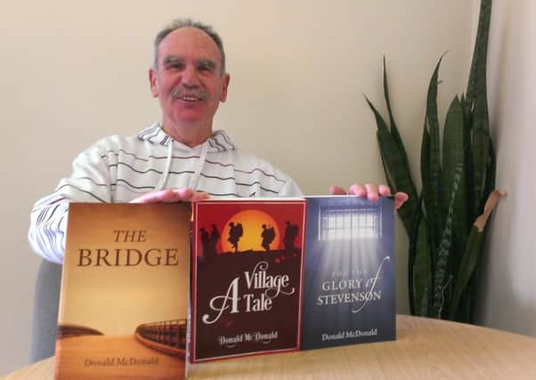 Donald McDonald with his books, The Bridge, A Village Tale and For the Glory of Stevenson SUS-150411-095534003