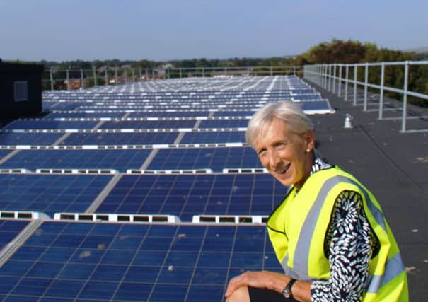 WSCC leader Louise Goldsmith with solar panels (photo submittted). SUS-160921-114117001