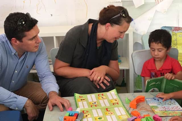 Bexhill and Battle MP Huw Merriman and Banbury MP Victoria Prentis with a child refugee in Jordan SUS-160921-151826001