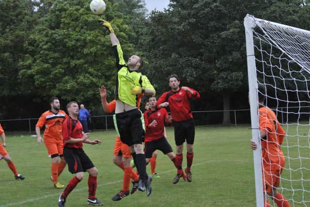 The JC Tackleway goalkeeper gets his hand to a Rye cross. Picture by Simon Newstead