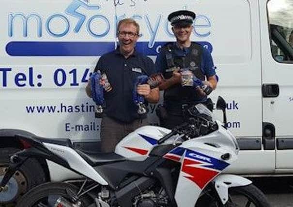 Billy Sutton of Hastings Motorcycle Centre with PCSO Daryl Holter and the padlocks on offer SUS-160923-144050001