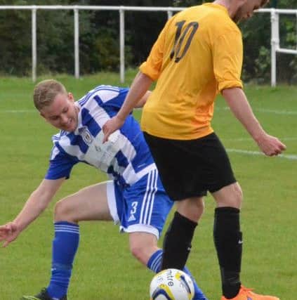 Bailie Rogers nicks the ball from an opponent. Westfield v Haywards Heath Town. Picture by Grahame Lehkyj