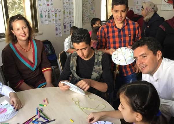 Huw Merriman MP and Victoria Prentis MP with refugees at an education centre in a camp in Jordan SUS-160928-153610001