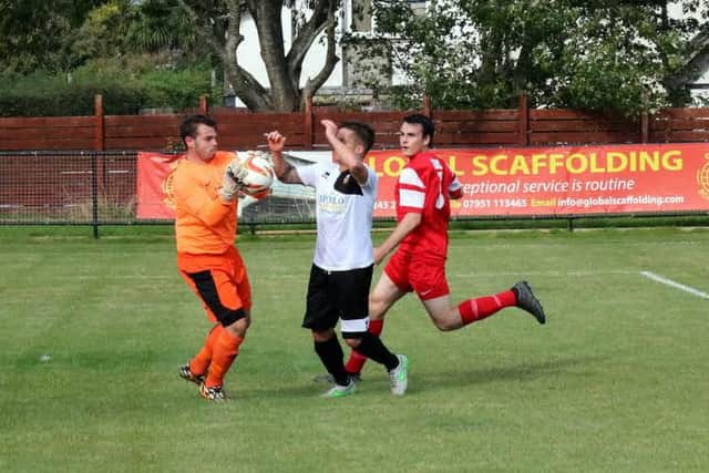 Horsham YMCA's Lewis Blaney claims the ball in Saturday's FA Vase clash