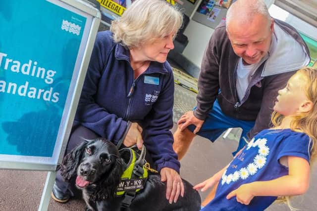Lee Ede, from East Sussex Trading Standards, with sniffer dog Phoebe and visitors to the event in St Leonards