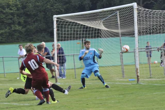 Jamie Crone fires into the side-netting during Little Common's weekend defeat to Wick. Picture by Simon Newstead
