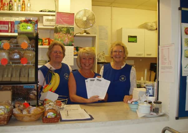 Volunteers at the tea bar with the completed surveys