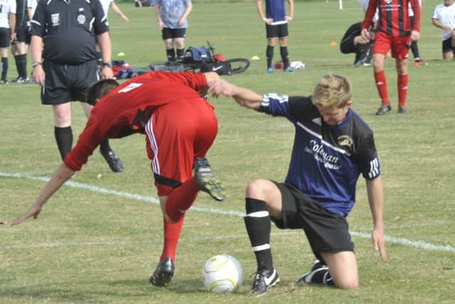 Hastings Rangers and Hollington United II tussle for possession. Picture by Simon Newstead
