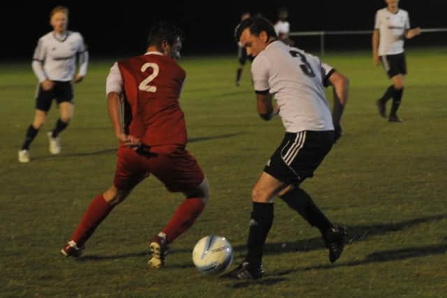 Bexhill United full-back Craig Ottley tussles for possession with Seaford Town's Craig Pooley. Picture by Simon Newstead