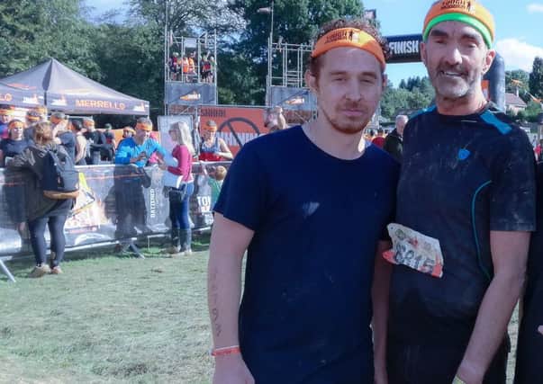 Roger Wolstencroft, right, and Narciso Baldo, known as Ciso, at the finish line of Tough Mudder