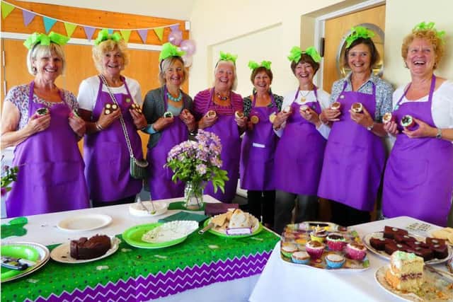 Yacht club cake crew in Macmillan colours, left to right, Marion Barker, Jean King, Anne Cole, Jan Dunnett, Helen Jupp, Jean Buttery, Sue Brown and Carole Middleton