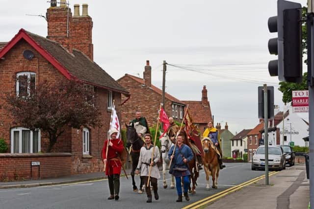 The marchers provided an unusual sight as they walked through residential streets on day two of their journey. Picture: Anthony Chappel-Ross for English Heritage SUS-160929-143919001