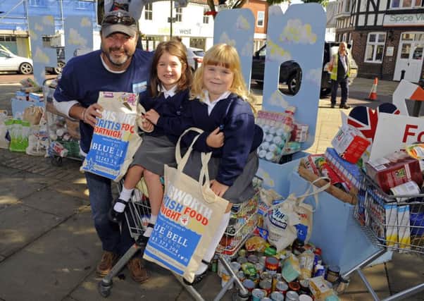 A special Community Harvest Festival Service with Emsworth Churches and Schools helped bring Food Fortnight to an end - pictured are Alistair Gibson, from the group of organisers, with Ruby Luxon (5), and Chloe Traill (5) from Emsworth / Picture by Malcolm Wells (161002-9102)