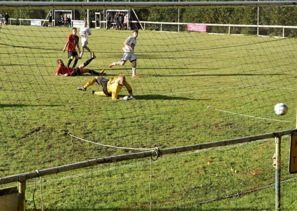 Michael Wood scores for Loxwood against AFC Uckfield Town. Picture by Matt Camp