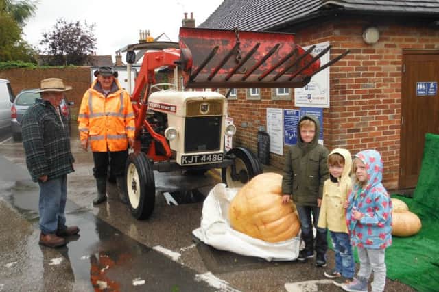 Malcolm Atterbury took along his tractor and hoist to weigh the pumpkins
